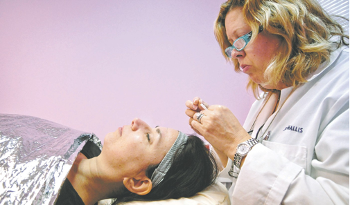 Dr. Laurie Mallis performs acupuncture on Poughkeepsie Journal columnist Linda Freeman at Searchlight Medical in the Town of East Fishkill. KARL RABE/LIVING & BEING